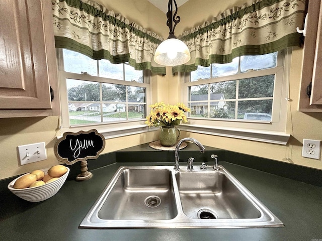 1828 Dove Dr, Benton, AR 72015 - kitchen view of a sink, decorative light fixtures, and dark countertops