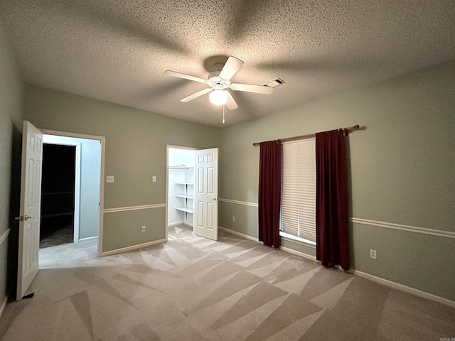 1828 Dove Dr, Benton, AR 72015 - unfurnished bedroom featuring light colored carpet, ceiling fan, baseboards, and a textured ceiling