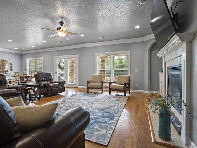 57 Excelso Way, Hot Springs Village, AR 71909 - living area with ceiling fan, a textured ceiling, arched walkways, crown molding, and light wood finished floors