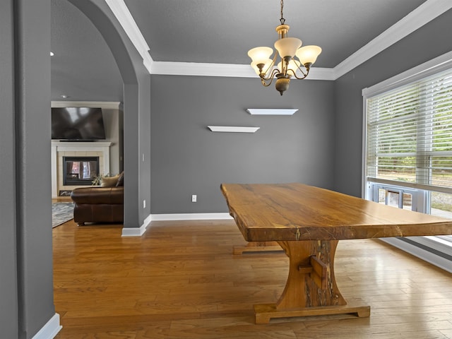 57 Excelso Way, Hot Springs Village, AR 71909 - dining room with arched walkways, ornamental molding, a chandelier, baseboards, and wood finished floors