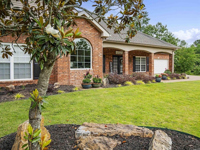 57 Excelso Way, Hot Springs Village, AR 71909 - view of front facade featuring brick siding, a front yard, an attached garage, and roof with shingles