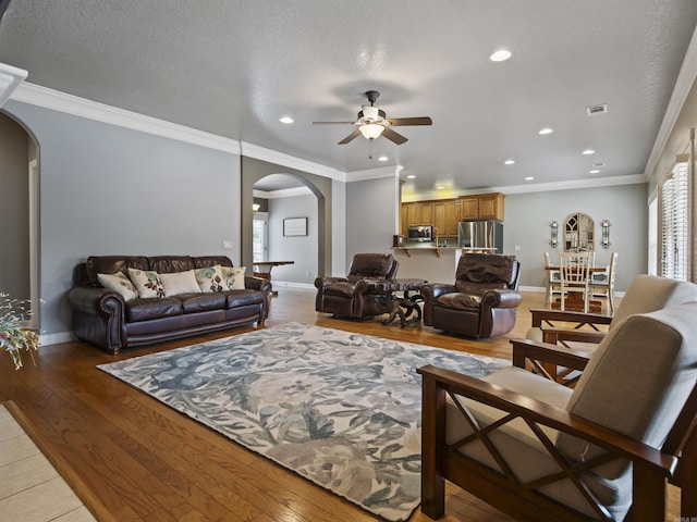 57 Excelso Way, Hot Springs Village, AR 71909 - living room with arched walkways, ceiling fan, healthy amount of natural light, baseboards, and recessed lighting