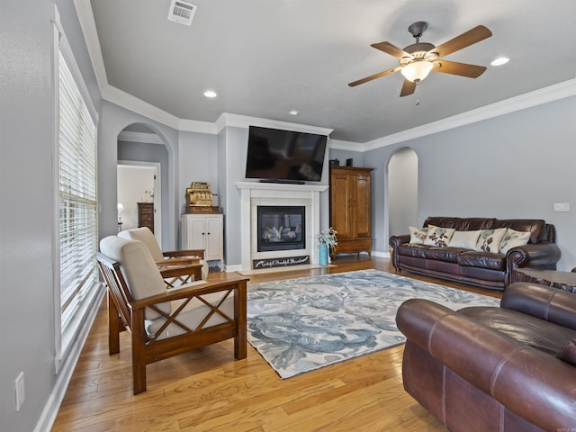 57 Excelso Way, Hot Springs Village, AR 71909 - living room featuring arched walkways, ceiling fan, light wood-style flooring, ornamental molding, and recessed lighting
