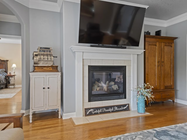 57 Excelso Way, Hot Springs Village, AR 71909 - detailed view of wood finished floors, ornamental molding, arched walkways, baseboards, and a tiled fireplace