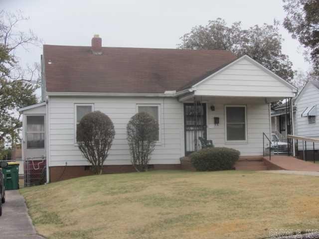 1710 N Magnolia, North Little Rock, AR 72114 - view of front facade with a front yard, a chimney, covered porch, and roof with shingles