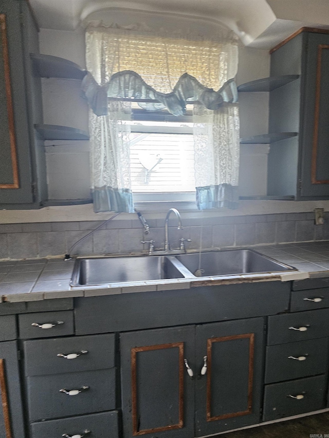 1710 N Magnolia, North Little Rock, AR 72114 - kitchen with open shelves, tile counters, a sink, and tasteful backsplash