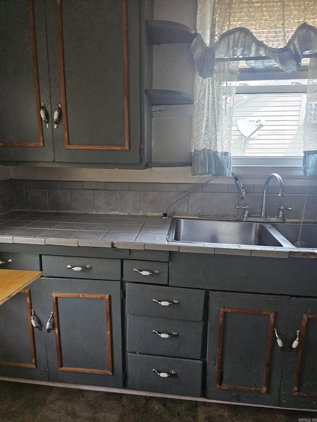 1710 N Magnolia, North Little Rock, AR 72114 - kitchen featuring a sink, backsplash, tile countertops, and gray cabinets