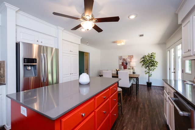 69 Quail Valley Rd, Sherwood, AR 72120 - kitchen with appliances with stainless steel finishes, a center island, a ceiling fan, white cabinetry, and ornamental molding