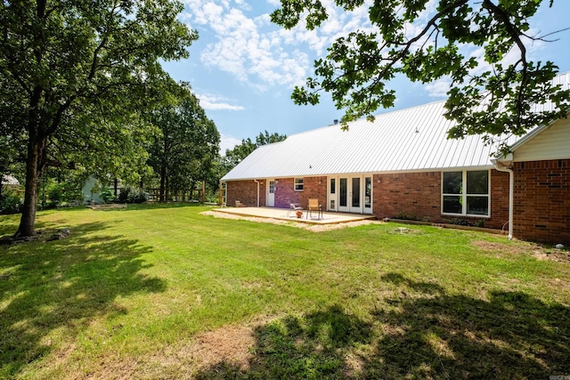 69 Quail Valley Rd, Sherwood, AR 72120 - rear view of property with french doors, brick siding, and a patio area