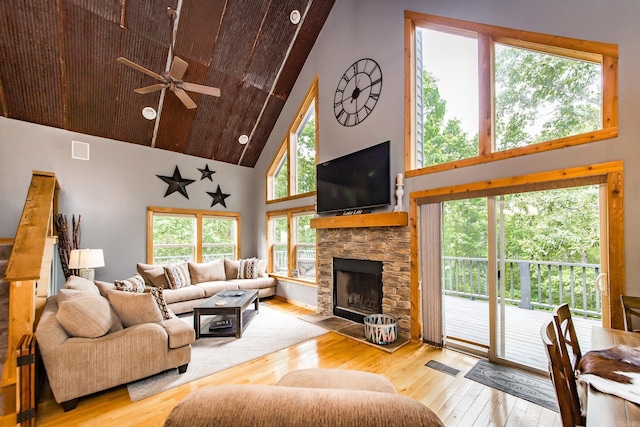 220 Brown Rd, Greers Ferry, AR 72067 - living room with high vaulted ceiling, hardwood / wood-style flooring, a ceiling fan, and a stone fireplace