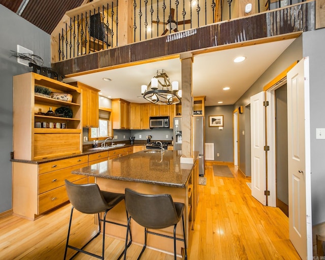 220 Brown Rd, Greers Ferry, AR 72067 - kitchen with stainless steel appliances, a sink, open shelves, light wood-type flooring, and baseboards