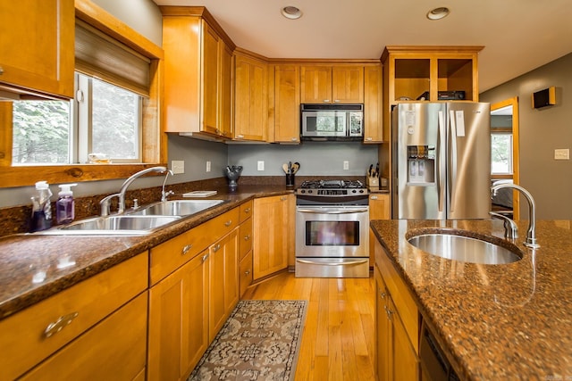 220 Brown Rd, Greers Ferry, AR 72067 - kitchen with appliances with stainless steel finishes, a sink, brown cabinets, light wood-style floors, and recessed lighting