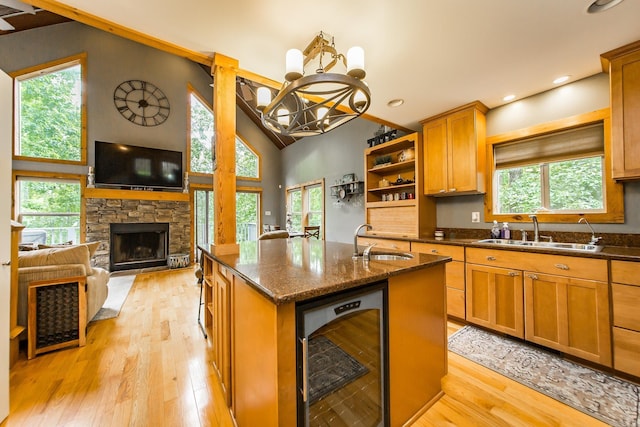 220 Brown Rd, Greers Ferry, AR 72067 - kitchen with wine cooler, a sink, a center island with sink, plenty of natural light, and high vaulted ceiling