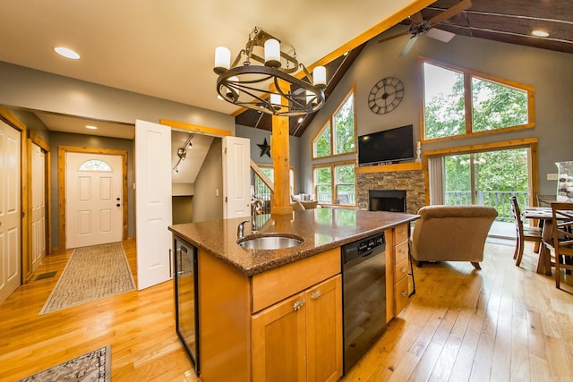 220 Brown Rd, Greers Ferry, AR 72067 - kitchen with black dishwasher, a sink, light wood-style floors, open floor plan, and high vaulted ceiling