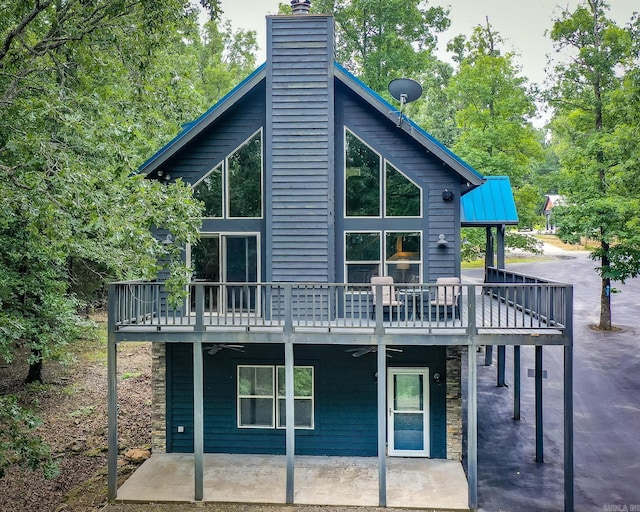 220 Brown Rd, Greers Ferry, AR 72067 - back of property featuring ceiling fan, a chimney, a patio area, stone siding, and a deck