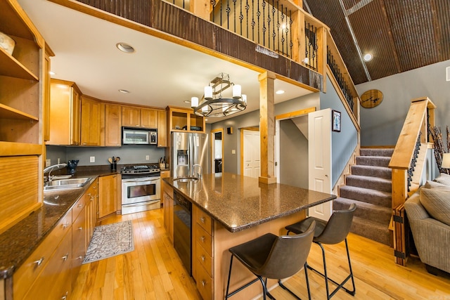 220 Brown Rd, Greers Ferry, AR 72067 - kitchen featuring stainless steel appliances, a sink, light wood finished floors, a kitchen breakfast bar, and recessed lighting