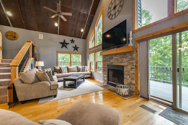 220 Brown Rd, Greers Ferry, AR 72067 - living area featuring high vaulted ceiling, hardwood / wood-style floors, wooden ceiling, ceiling fan, and stairway