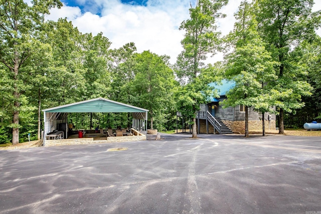 220 Brown Rd, Greers Ferry, AR 72067 - view of car parking with stairs, a detached carport, and driveway