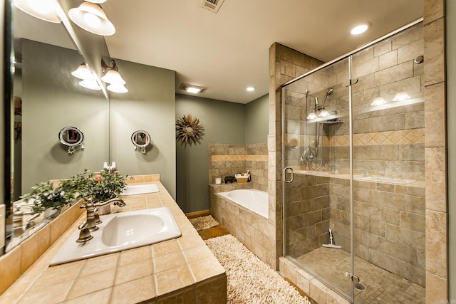 220 Brown Rd, Greers Ferry, AR 72067 - full bathroom featuring a bath, double vanity, a shower stall, and recessed lighting