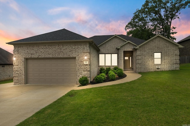 1569 Marquee Cir, Cabot, AR 72023 - view of front of home featuring driveway, a yard, brick siding, a garage, and roof with shingles