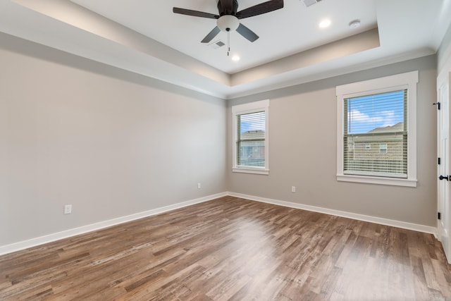 1569 Marquee Cir, Cabot, AR 72023 - unfurnished room with a tray ceiling, wood finished floors, baseboards, ceiling fan, and recessed lighting
