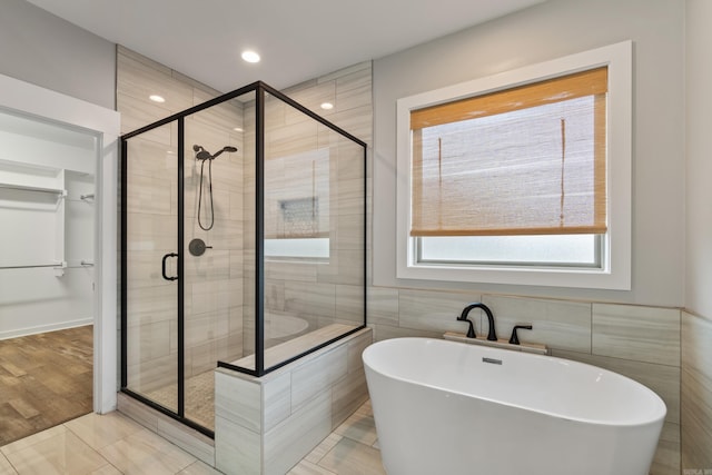 1569 Marquee Cir, Cabot, AR 72023 - bathroom featuring a freestanding bath, a shower stall, and tile walls