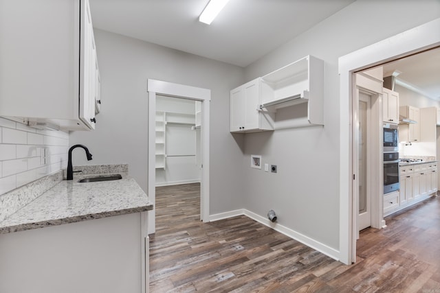 1569 Marquee Cir, Cabot, AR 72023 - washroom featuring cabinet space, hookup for an electric dryer, dark wood-style floors, baseboards, and washer hookup