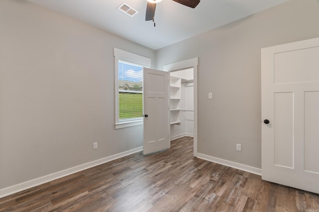 1569 Marquee Cir, Cabot, AR 72023 - unfurnished bedroom featuring wood finished floors, baseboards, a walk in closet, and a ceiling fan