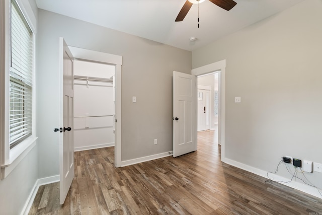 1569 Marquee Cir, Cabot, AR 72023 - unfurnished bedroom featuring wood finished floors, baseboards, a spacious closet, a closet, and ceiling fan