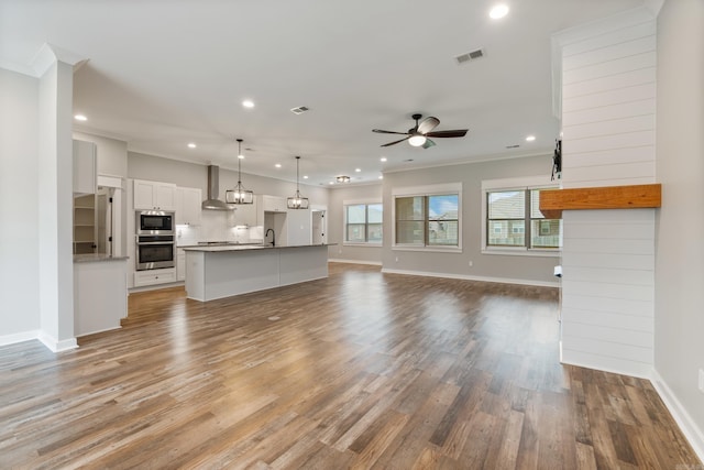 1569 Marquee Cir, Cabot, AR 72023 - unfurnished living room with crown molding, a ceiling fan, recessed lighting, a sink, and light wood finished floors