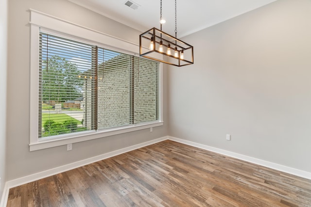 1569 Marquee Cir, Cabot, AR 72023 - unfurnished dining area featuring a chandelier, baseboards, and wood finished floors
