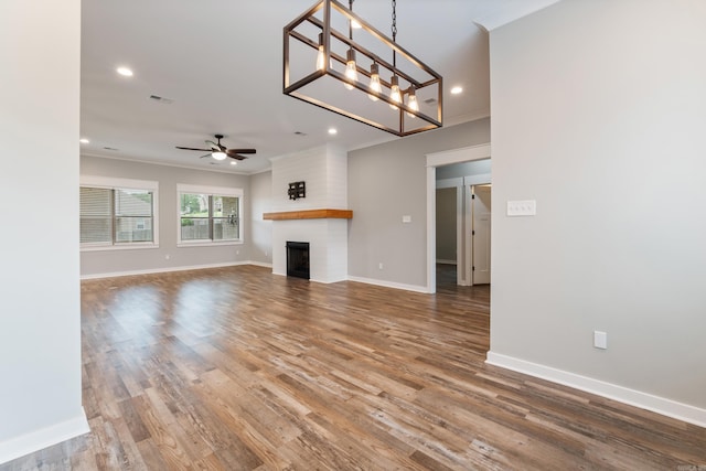 1569 Marquee Cir, Cabot, AR 72023 - unfurnished living room with ceiling fan, ornamental molding, baseboards, wood finished floors, and recessed lighting