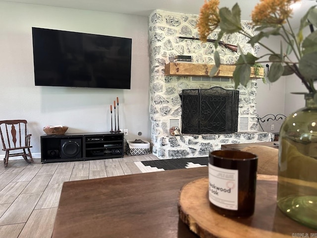 9 Whispering Dr, Alexander, AR 72002 - living area featuring a fireplace and wood finish floors