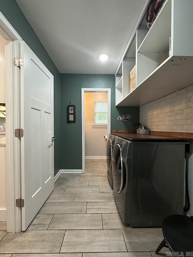 9 Whispering Dr, Alexander, AR 72002 - laundry area featuring wood tiled floors, washing machine and dryer, and baseboards