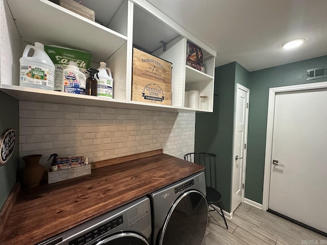 9 Whispering Dr, Alexander, AR 72002 - laundry room featuring washing machine and dryer, light wood-style flooring, and baseboards