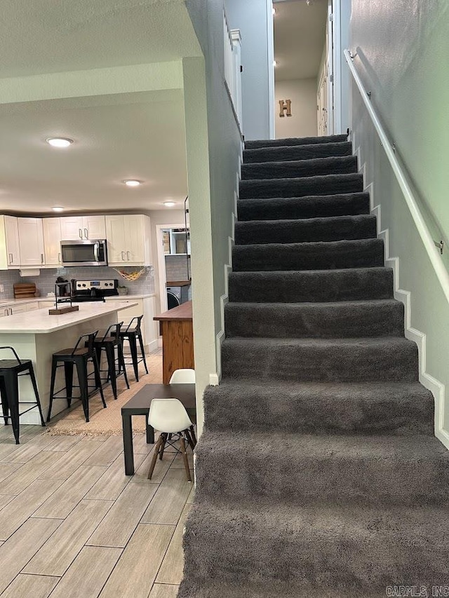 9 Whispering Dr, Alexander, AR 72002 - stairway with wood finish floors and recessed lighting