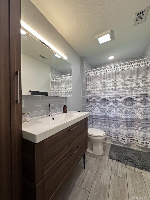 9 Whispering Dr, Alexander, AR 72002 - bathroom with toilet, vanity, tasteful backsplash, wood finish floors, and a shower with curtain