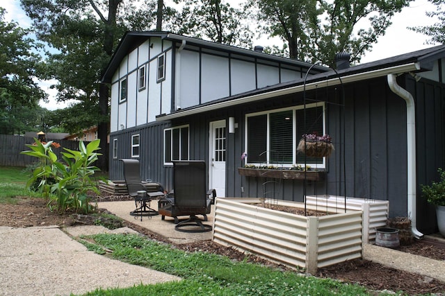 9 Whispering Dr, Alexander, AR 72002 - view of front facade with board and batten siding and a patio