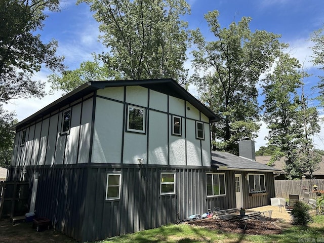 9 Whispering Dr, Alexander, AR 72002 - view of property exterior with board and batten siding and a chimney
