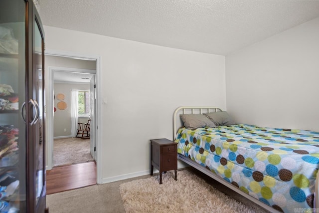 21 Evergreen Park, Cabot, AR 72023 - carpeted bedroom featuring fridge, baseboards, and a textured ceiling