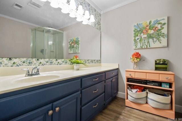 21 Evergreen Park, Cabot, AR 72023 - bathroom featuring crown molding, a stall shower, double vanity, and wood finished floors