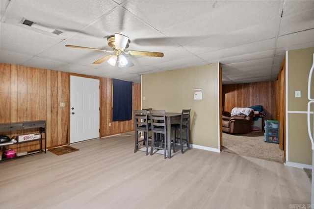 21 Evergreen Park, Cabot, AR 72023 - dining area featuring wood walls, a paneled ceiling, light wood-style flooring, a ceiling fan, and baseboards
