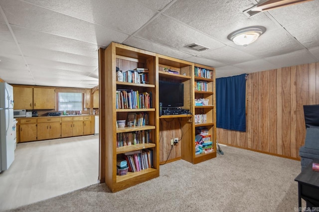 21 Evergreen Park, Cabot, AR 72023 - interior space with wood walls, a drop ceiling, light colored carpet, and freestanding refrigerator