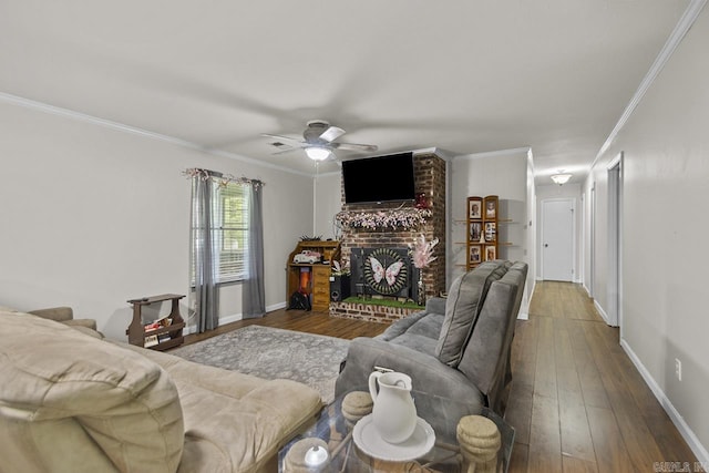 21 Evergreen Park, Cabot, AR 72023 - living room with crown molding, hardwood / wood-style flooring, a ceiling fan, a brick fireplace, and baseboards