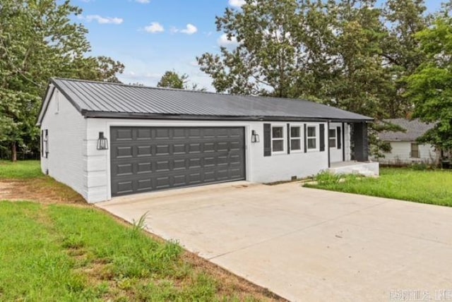 1506 N Pratt St, Pocahontas, AR 72455 - view of front of property with concrete driveway, a garage, a front yard, and metal roof