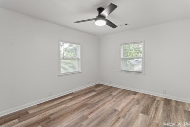 1506 N Pratt St, Pocahontas, AR 72455 - empty room featuring healthy amount of natural light, light wood-type flooring, and baseboards