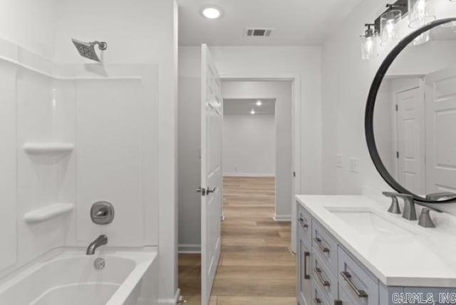 1506 N Pratt St, Pocahontas, AR 72455 - bathroom with vanity, wood finished floors, recessed lighting, shower / bathtub combination, and baseboards