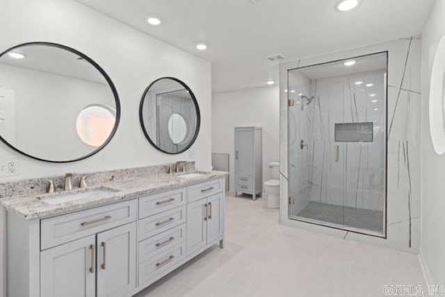 1506 N Pratt St, Pocahontas, AR 72455 - bathroom featuring a marble finish shower, toilet, double vanity, and recessed lighting