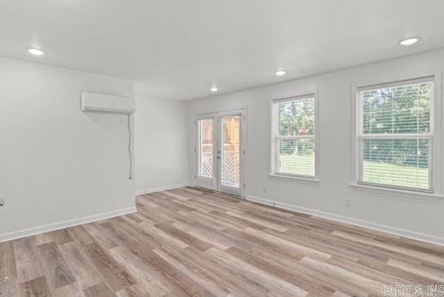 1506 N Pratt St, Pocahontas, AR 72455 - spare room with an AC wall unit, light wood finished floors, baseboards, and recessed lighting
