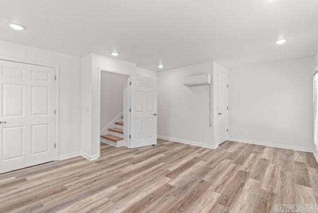 1506 N Pratt St, Pocahontas, AR 72455 - basement featuring recessed lighting, a wall mounted AC, wood finished floors, baseboards, and stairs